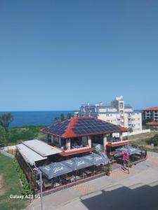 a building with a roof with solar panels on it at Апартамент Нина in Byala