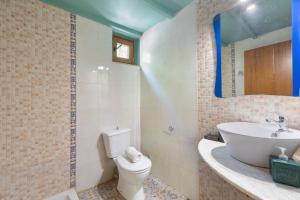 a bathroom with a toilet and a sink at Akros Oreon, Omalos Studio in Káto Sími +24 photos