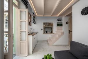 a living room with a staircase and a couch at Symi Duo in Symi