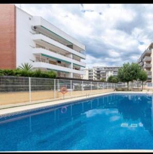a large swimming pool in front of a building at Acuario I RR18 in La Pineda