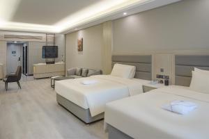 a hotel room with two beds and a television at Atour Hotel Hotan Unity Plaza in Hoten +32 photos