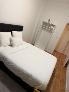 a white bed with white sheets and pillows in a room at Ejon in Lelystad