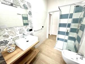 a bathroom with a sink and a shower at Blue Diamond in Vibo Valentia Marina +30 photos
