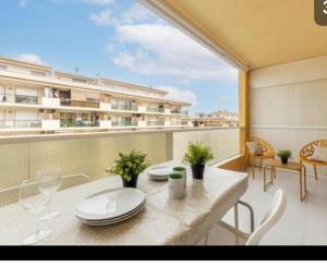 a balcony with a table and chairs and a building at Acuario I RR18 in La Pineda