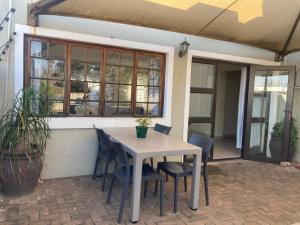 a table and chairs in front of a house at 51 on Parfitt in Bloemfontein