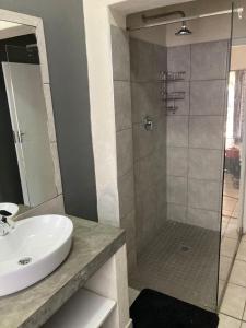 a bathroom with a sink and a shower at 51 on Parfitt in Bloemfontein +48 photos