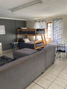 a living room with a couch and bunk beds at 51 on Parfitt in Bloemfontein
