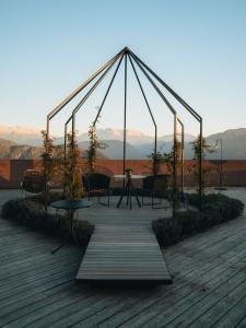 a pavilion with a table and chairs on a deck at Hotel Belvedere - Fine Dining, Hideaway & SPA in San Genesio Atesino