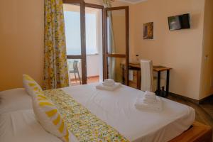 a bedroom with a bed with two towels on it at Agriturismo Sant'Anna in Sanremo +54 photos