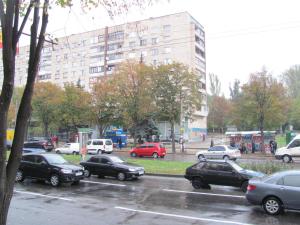 a bunch of cars parked in a parking lot at Apartment on Sobornyi Avenue in Zaporozhye