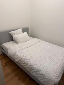 a bed with white sheets and a pillow on it at Ejon in Lelystad