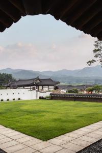 a view of a building with a green lawn at 한옥스테이 화랑루 in Gyeongju