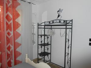 a room with a black rack with clothes at Herault Maraussan in Maraussan