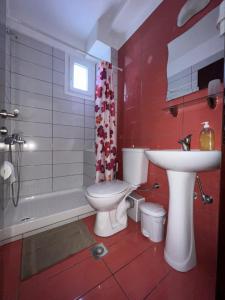 a bathroom with a white toilet and a sink at Marie Claire Studios in Olympic Beach