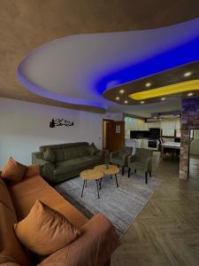 a living room with a couch and a table at Vlasic Odmor - Villa Wellnes & spa in Vlasic