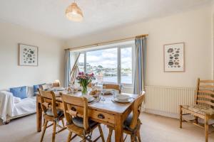 a dining room with a table and a large window at 3 Bed in Polruan oc-pc049 in Fowey