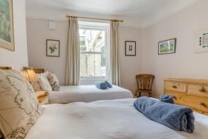 a bedroom with two beds and a window at 3 Bed in Polruan oc-pc049 in Fowey