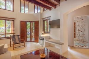 a living room with a desk and a table at Villas HM Paraiso del Mar in Holbox Island