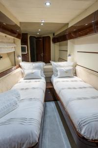 two beds in the middle of a room at Only One Yacht Cape Town in Cape Town