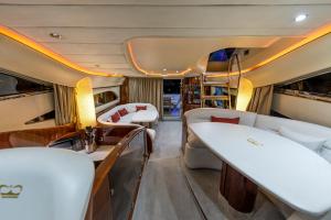 an inside view of a luxury yacht with beds and tables at Only One Yacht Cape Town in Cape Town