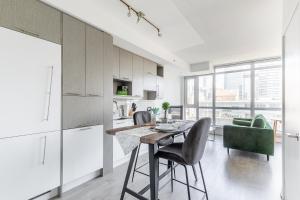 a kitchen and dining room with a table and chairs at Atlantis Suites The Entertainment District - Toronto in Toronto