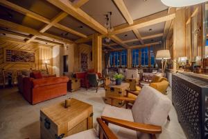 a large living room with wooden ceilings and furniture at Kamper Park Babia Góra - parcele kamperowe in Zawoja