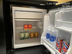 an open refrigerator with food and drinks in it at Hai Dang Hotel Ha Tinh in Hà Tĩnh