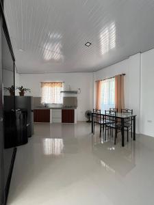 a large room with a table and chairs in it at SabinaGateway Suites in Panglao Island