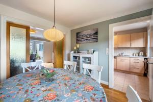 a dining room and kitchen with a table and chairs at Park – House in Oldenburg in Holstein