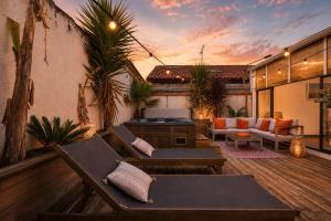 an outdoor patio with chairs and a grill at Villa NOVA in Capbreton
