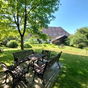 a picnic table and benches in a park at Klosterblick in Bad Doberan