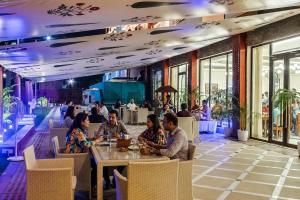 a group of people sitting at a table in a restaurant at Bhagirathi By Atishay in Haridwār +148 photos