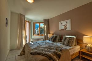 a bedroom with a bed and a deer on the wall at Haus Belvédère in Arosa