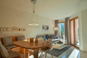 a living room with a table and a couch at Haus Belvédère in Arosa
