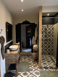 a bathroom with a sink and a room with a bedroom at Apart'é in Saint-Brisson-sur-Loire +35 photos