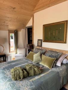 a bedroom with a large bed with a large painting on the wall at Apart'é in Saint-Brisson-sur-Loire
