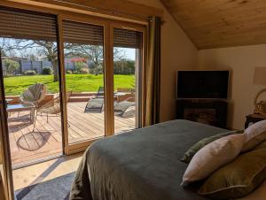 a bedroom with a bed and a sliding glass door at Apart'é in Saint-Brisson-sur-Loire