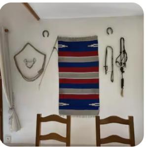 two chairs and a towel hanging on a wall at Gite Rando Marquenterre in Rue