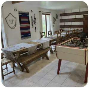 a kitchen with tables and a stove in a room at Gite Rando Marquenterre in Rue