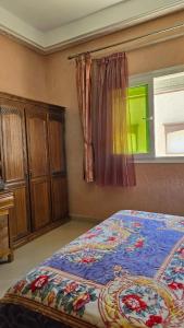 a bedroom with a bed and a window at Appement in Agadir nʼ Aït Sa