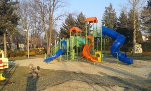 a playground with a slide in a park at Petra Vendégház in Bük