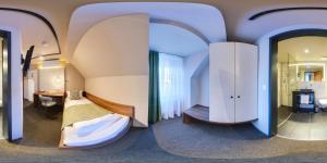 a bedroom with a bed and a desk and a mirror at JOESEPP´S HOTEL am Hallhof in Memmingen +46 photos