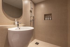 a bathroom with a sink and a shower with a mirror at 한옥스테이 화랑루 in Gyeongju +110 photos