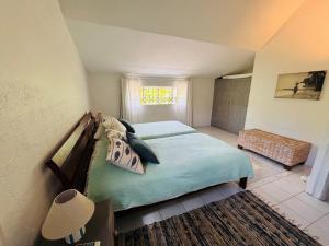 a bedroom with a bed and a window at Villa Laposte in Rivière Noire +17 photos