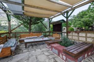 a patio with a ping pong table and benches at Akros Oreon, Omalos Studio in Káto Sími