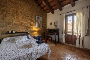 a bedroom with a bed and a desk in it at Casa Sorrapa in Deltebre