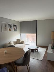 a living room with a couch and a table at Premium T1 - Blue Ocean in Espinho