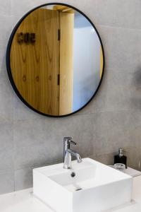 a bathroom with a sink and a mirror at Jianshanxi Designer Hotel in Mount Siguniang