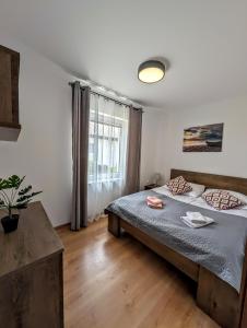 a bedroom with a large bed and a window at Domki i Pokoje Baltimor in Grzybowo +107 photos