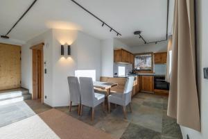 a kitchen with a dining room table and chairs at Appartementhaus Moritz in Reith bei Seefeld
